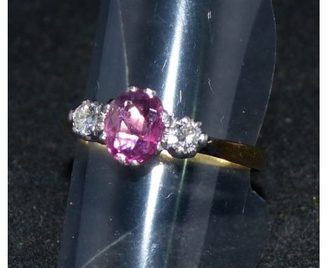 An 18 carat gold dress ring set ruby with 2 diamonds