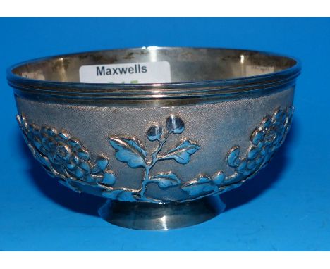 A 19th century Chinese silver bowl with Prunus decoration in relief on stippled ground, 4.3 oz.