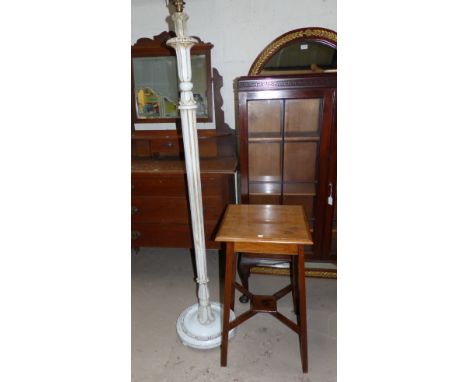 An Edwardian oak square top side table; a cream standard lamp; a needlework firescreen; a bed table; a bookrack