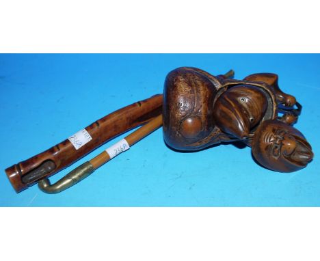 An unusual Japanese opium pipe with brass mounts and bamboo effect holder together with carved bamboo toggle / pouch with 2 i