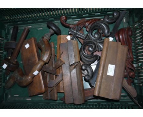 A collection of old woodworking tools including planes, carved furniture mounts; etc.