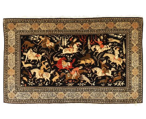 A Persian silk Qum pictorial rug, second quarter 20th century, the central field depicting huntsmen on horseback, on a black 