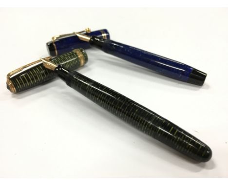 A vintage Parker Duofold Lapis Lazuli fountain pen with gold trim together with a green pearl Parker Vacumatic, both with 14 