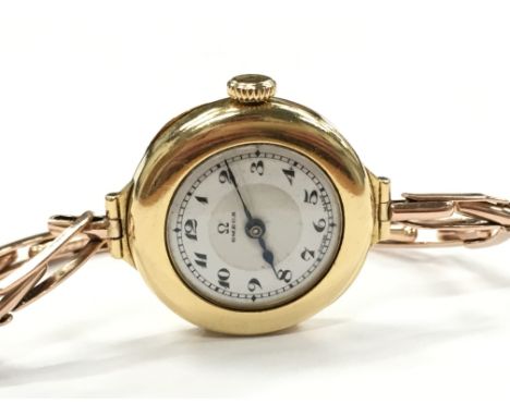 A ladies 18ct gold cased Omega wristwatch, white enamel dial with Arabic numerals, cased No 6505987, Mov No 7027801, manual w