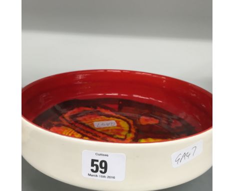 A Poole Pottery Delphis fruit bowl, shape 89, decorated in an abstract pattern by Carol Cutler on red ground.
