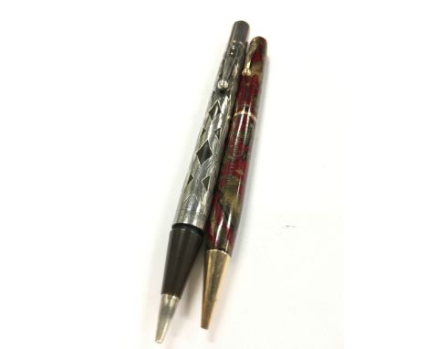 Two vintage Waterman's propelling pencils, one with a sterling silver floral overaly.