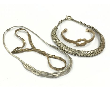 A bag containing a heavy Ethnic silver collar together with two other silver necklaces and a bangle.
