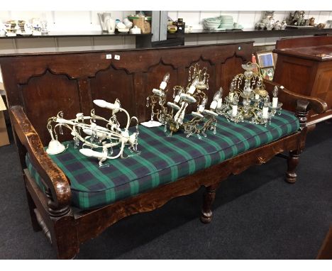 A large oak panelled hall bench resting on pad feet with upholstered cushion seating.