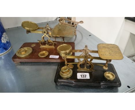 Two sets of brass postal scales and weights.