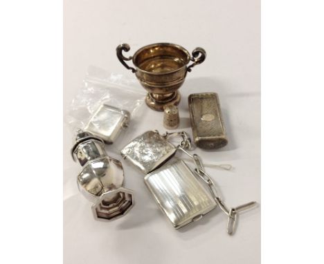 A collection of various silver items including Vesta cases, miniature trophy cup, pepperette, snuff box, matchbook holder and