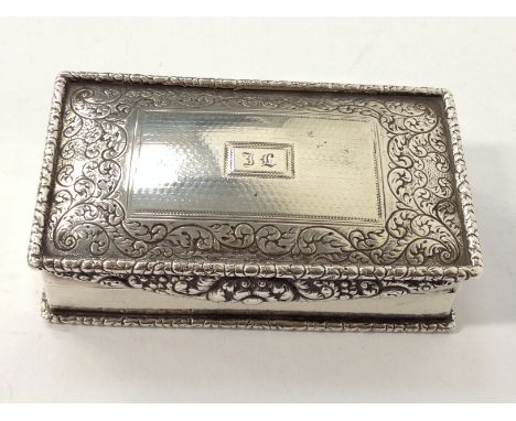 A Georgian silver snuff box with floreat engraved lid and catch and gilded interior by Michael Starkey: London 1810. (10.2 x 