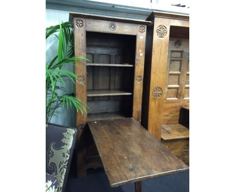 A narrow French fruitwood open front bookcase with solid doors below, fold down desk/table to front, circular carved motifs t