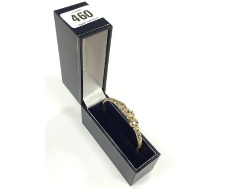 A 9 carat gold sapphire and diamond set Jaguar bangle.