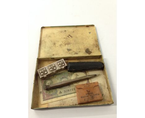 A silver cased engine turned propelling pencil together with a button hook and other items in Players Navy Cut cigarette tin.