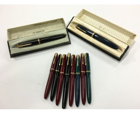 A quantity of vintage Parker fountain pens including two original boxed Duofolds and various other models.