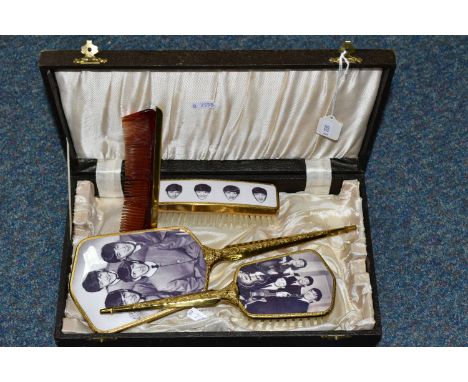 THE BEATLES, A CASED DRESSING TABLE SET in lidded and lined covered wooden case with mirror and two brushes featuring images 