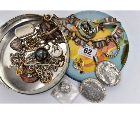 A SMALL TIN OF ASSORTED ITEMS, to include a rose metal lavalier pendant set with garnet and split pearls, stamped 9c, approxi