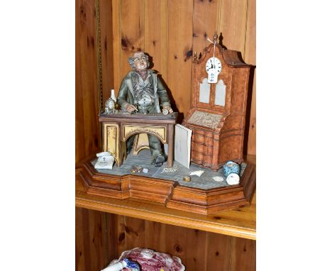 A CAPODIMONTE PORCELAIN TABLEAU 'THE CLOCK MAKER', sculpted by Mario Angela, modelled as a gentleman seated at his desk fixin