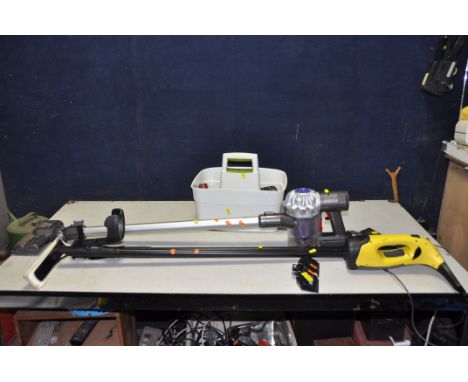 A DYSON V6 CORDLESS VACUUM CLEANER with a tool caddy containing accessories for Dyson and a Karcher Window Vac with mop, two 