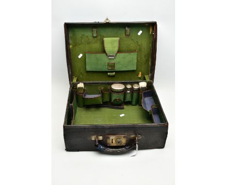 A GEORGE V BLACK LEATHER DRESSING CASE, green fabric lined interior with brown leather trim, the incomplete fittings comprisi