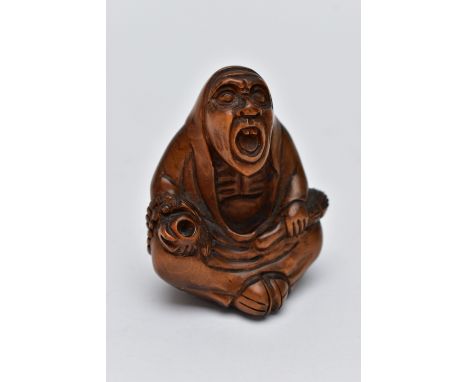 A CARVED NETSUKE FIGURE, in the form of a seated robed elder, drill holes to the back, approximate height 54.2mm