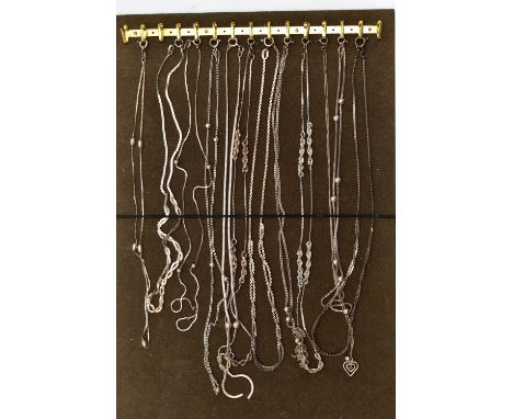 A TRAY OF WHITE METAL CHAINS, twelve chains in total of various styles, all fitted with spring clasps, some with marks to ind