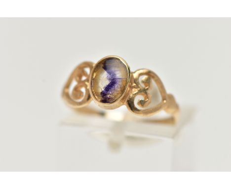 A 9CT GOLD BLUE JOHN FLUORITE RING, designed with an oval blue john fluorite cabochon, collet set, openwork heart shoulders l