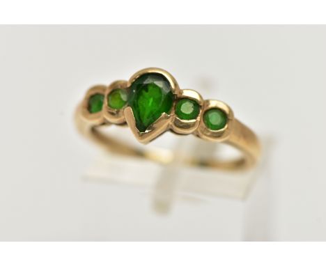 A 9CT GOLD CHROME DIOPSIDE RING, designed with a central pear cut stone flanked with four smaller circular cut chrome diopsid