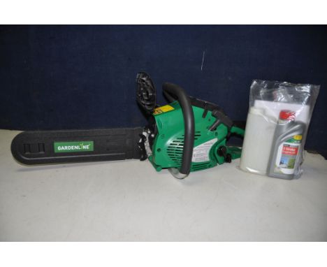 A GARDENLINE CSP41 49cc PETROL CHAINSAW along with a bottle of two stroke oil and a mixing bottle (engine pulling freely but 