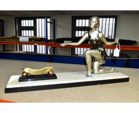 AN ART DECO FIGURAL PHOTOGRAPH FRAME, the painted spelter kneeling female figure, wearing a short flapper style dress, gestur