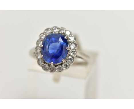 A SAPPHIRE AND DIAMOND CLUSTER RING, set with a mixed cut, cushion sapphire, measuring approximately 9.28 x 8.0mm x depth 5.9