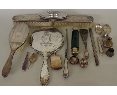 An engine turned silver three piece dressing table brush set;&nbsp;together with a silver hand mirror; a green glass double e