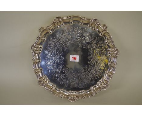 A Victorian silver salver,&nbsp;on four shell feet,&nbsp;by Henry Wilkinson &amp; Co,&nbsp;Sheffield 1854, 30cm diameter, 669