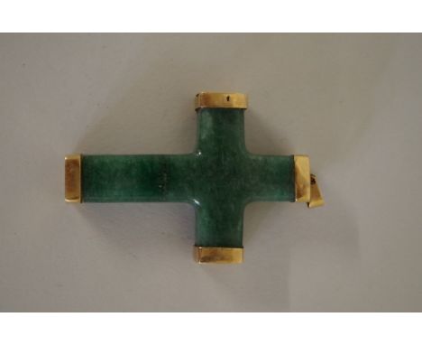 A chunky green jade cross having yellow metal mounts, 60mm x 38mm. 
