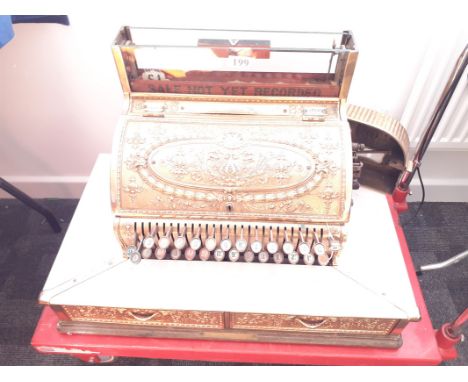 An American National Cash Register produced in Dayton Ohio,  with ornate cast brass surround, 28 keys, drawers with raised le