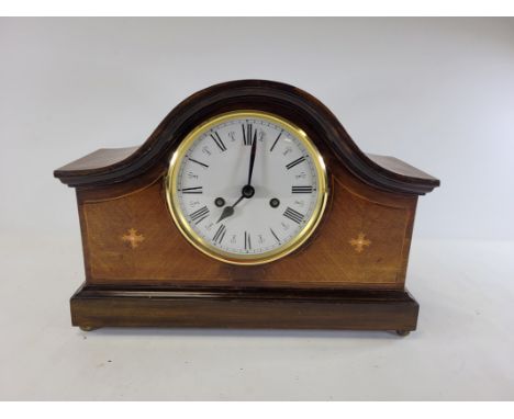 A 20th Century mahogany mantelpiece clock raised on four brass ball feet,  with enamel dial and Roman numerals, 27cm x 38cm  