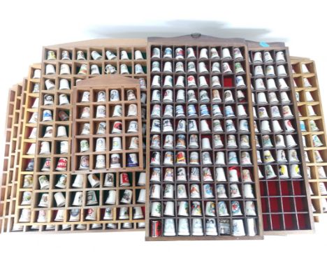 An extensive collection of ceramic thimbles,  consisting of an array of subjects including 20th Century branding, geographica