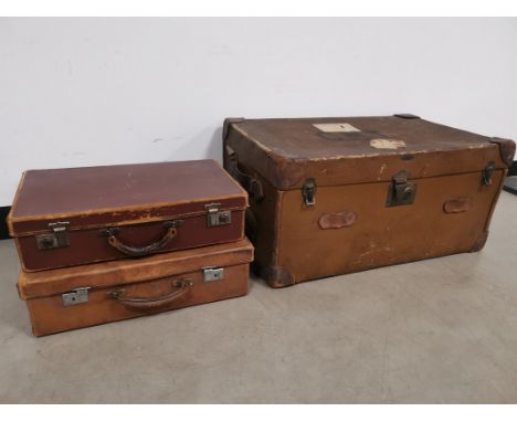 Two leather cases together with a large travel trunk,  having some partial labels to the exterior, 'C. M. T' printed to the t