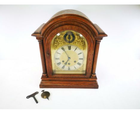 German oak cased chiming mantel clock,  with movement stamped Gustav Becker, together with key and pendulum. 32cm x 38cm x 18