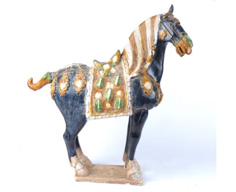 A large 20th Century Chinese sancai glazed statue of a horse after the Tang,  a/f with loss to ear, 66.5cm x 64cm x 19cm,  