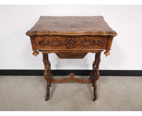 Burr walnut sewing table, with lidded compartment and carved pierced supports. 55cm W x 40cm D x 72cm H General light wear fr