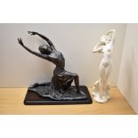A large cast patented metal figural study of a woman in a knelt position sold together with a cast