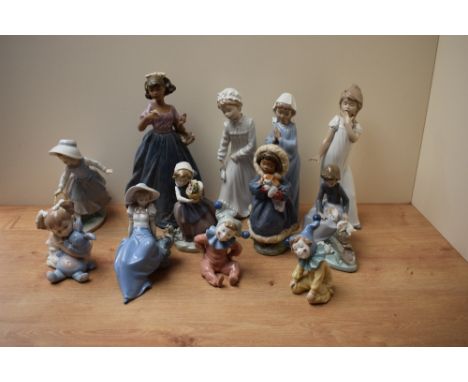 An assortment of Lladro and Nao by Lladro porcelain figures including 'Jingles' number 1065, 'Keep Me Warm' number 2419 in ma