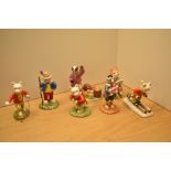 Five Royal Doulton Rupert Bear figurines comprising 'Rupert Takes A Skiing Lesson' RB 20, 'Rupert