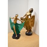 Two Art Deco style gilt and green painted figurines, both depicting women in long gowns/drapes. Both