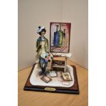 An Italian hand-painted ceramic figure depicting a youthful artist in a studio setting, measures
