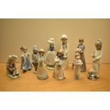 An assortment of Lladro and Nao by Lladro porcelain figures comprising 'Please Please' number