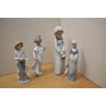 Two Nao by Lladro figurines 'Feeding The Goat' number 4590 and 'How Pretty' number 1110 sold