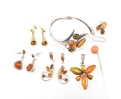 A collection of silver and amber jewellery and a coral stick pin. The collection of jewellery to include a silver and amber h