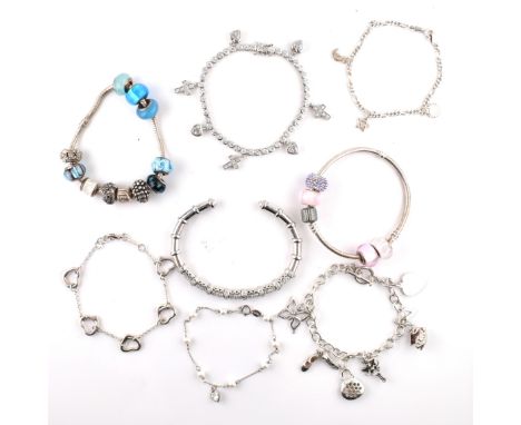 A collection of silver bracelets and charm bracelets. The lot to include a silver and CZ set tennis bracelet set with CZ set 